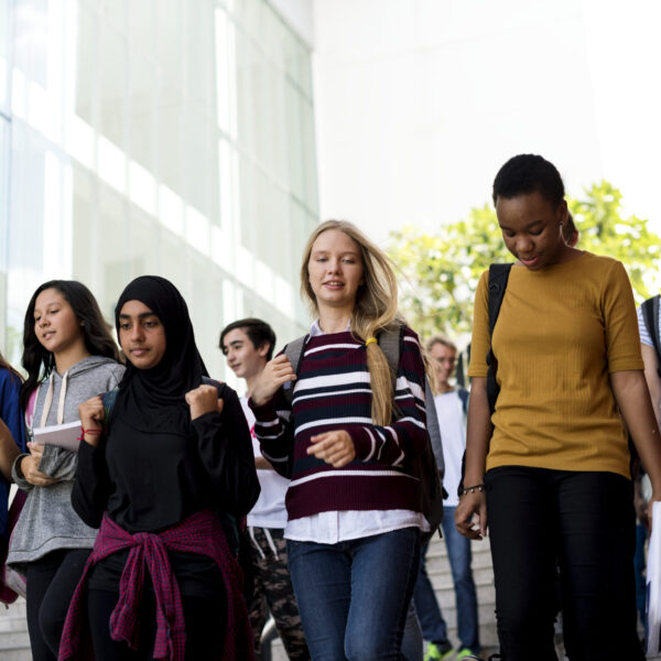 Diverse group of students walking in school