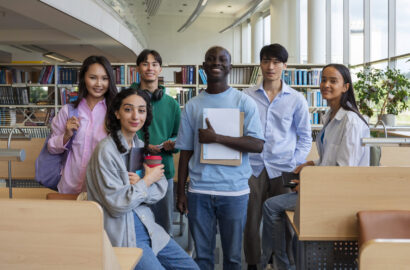 full-shot-smiley-students-library (1)